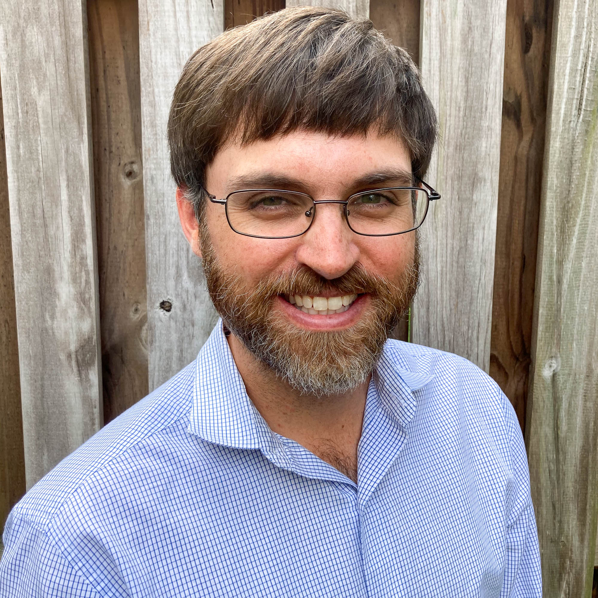 Smartphone business portrait showing uneven lighting and casual presentation.